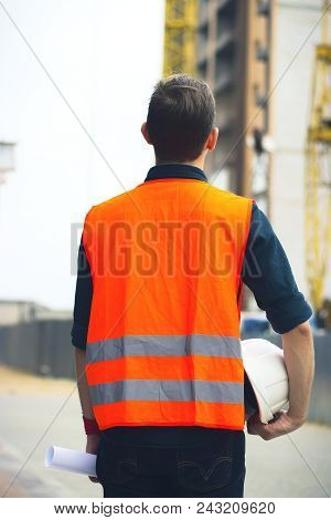 The Engineer Holding The White Helmet Safety At Construction Site With Crane Background Silhouette