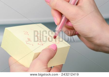 Closeup Woman's Hands Write On Yellow Sticker Paper Sheets Words I'm So Sorry And Laugthing Emoticon