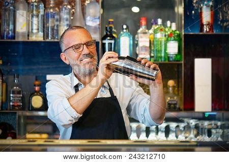 Professional Bartender Man Holding In Hands A Shaker With A Fresh Delicious Cocktail. Bartender Shak