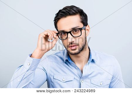 Head Shot Portrait Of Tempting Seductive Man With Black Hair In Glasses Holding Eyelet Of Spectacles