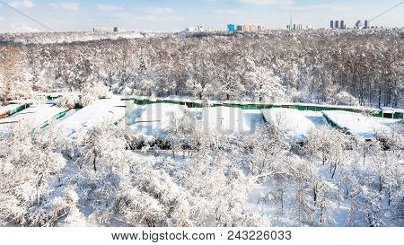 Moscow Cityscape With Snow-covered Garages Between Urban Timiryazevsky Park And Apple Orchard In Kop