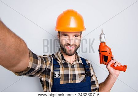 Self Portrait Of Cheerful Joyful Repairer In Protective Hard Hat Shooting Selfie On Front Camera Hav