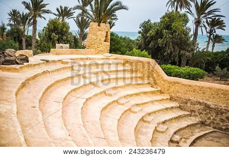 Classic Ancient Amphitheater In An Arab Town With Wicker Seats And Clay Steps