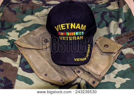 Vietnam Veteran Hat On Service Pouches On Camouflage Uniform