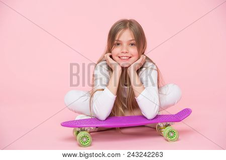 Skateboard Kid Lie On Floor On Pink Background. Child Skater Smiling With Longboard. Small Girl Smil