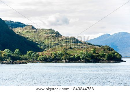 Landscape With Beautiful Green  Scottish Mountains,woodland And Lake With Reflection. Panoramic View