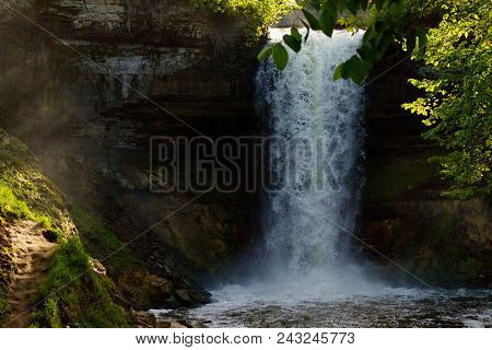 The Light Shines On The Narrow Path Of Minnehaha Falls In Minnesota