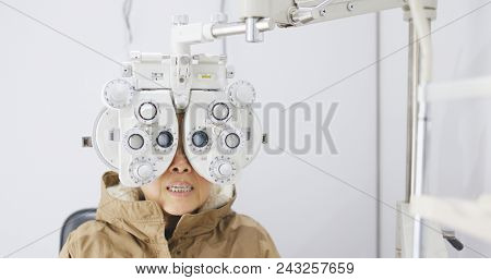 Asian Old woman checking on eye 