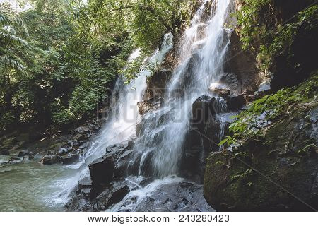 Scenic View Of Beautiful Kanto Lampo Waterfall, Green Plants And Rocks, Bali, Indonesia