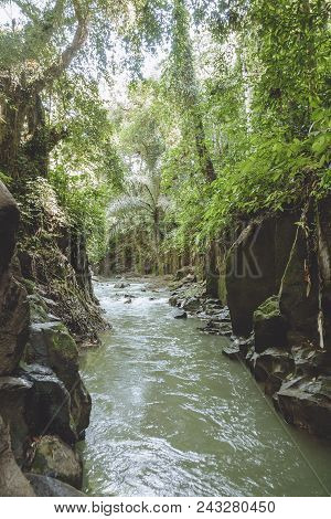 Scenic View Of River, Rocky Formations And Green Plants Near Kanto Lampo Waterfall, Bali, Indonesia