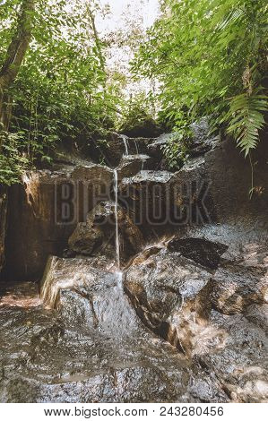 Scenic View Of Beautiful Kanto Lampo Waterfall, Green Plants And Rocks, Bali, Indonesia