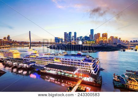 Cityscape And Skyline Of Downtown Near Water Of Chongqing At Night