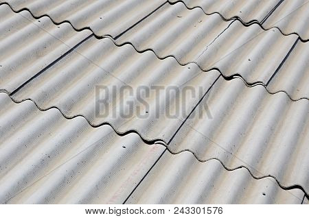 A Fragment Of A Gray Slate Roof Of An Old Sample Made Of Asbestos Material