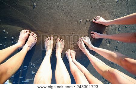 Ten Feet Of A Family Of Five Barefoot People On The Seashore In The Summer