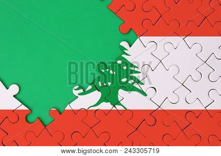 Lebanon Flag  Is Depicted On A Completed Jigsaw Puzzle With Free Green Copy Space On The Left Side.