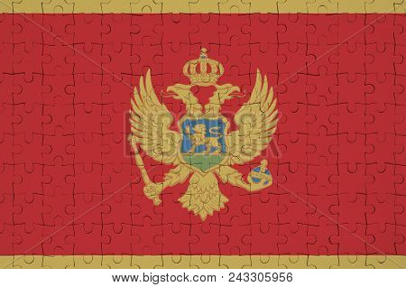 Montenegro Flag  Is Depicted On A Folded Puzzle