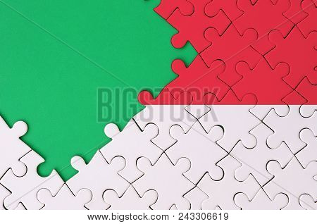 Singapore Flag  Is Depicted On A Completed Jigsaw Puzzle With Free Green Copy Space On The Left Side