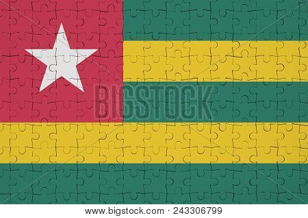 Togo Flag  Is Depicted On A Folded Puzzle