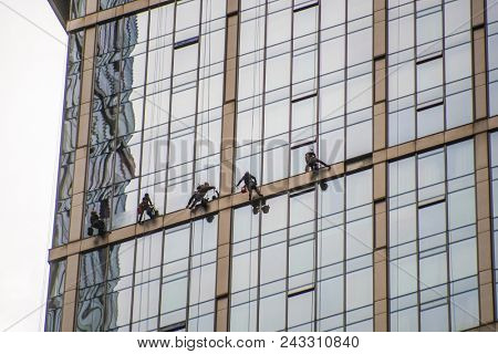 Moscow, Russia - May, 18, 2018: Steeplejacks work on a wall of Moscow city building