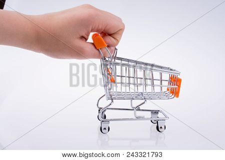 Hand Holding A Cart On A White Background