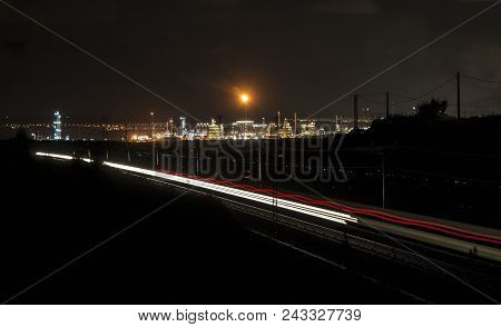 Factory Smoke Stack. Petrochemical Plant, Oil And Gas Refinery With Trai Lighttrails