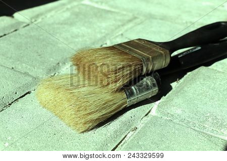 A Two Brushes On The Ground For Painting Some Wall. With Soft Bristles