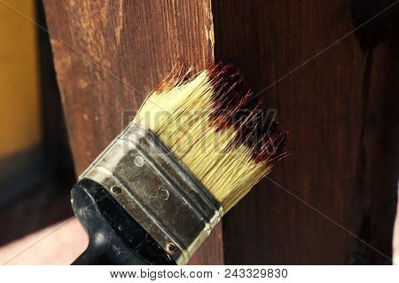 The Painter Who Painting Wooden Board With Small Brush In Outdoor