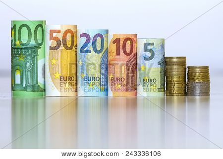 Straight Row Of Accurately Rolled Hundred, Fifty, Twenty, Ten And Five New Paper Euro Banknotes And 