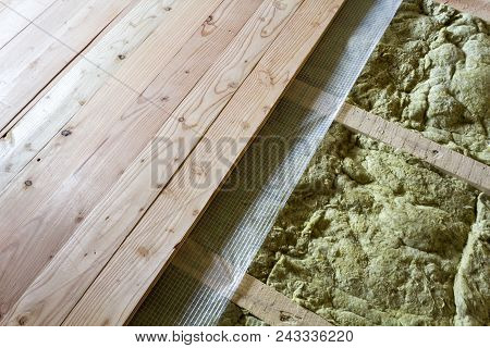 Installation Of New Floor Of Wooden Natural Planks And Mineral Wool Insulation For Isolation And Kee