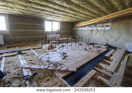 Big Spacious Light Empty Attic Room Under Construction And Renovation. Mansard Floor And Ceiling Ins