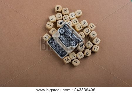 Letter Cubes Of Made Of Wood Around Model Typewritter