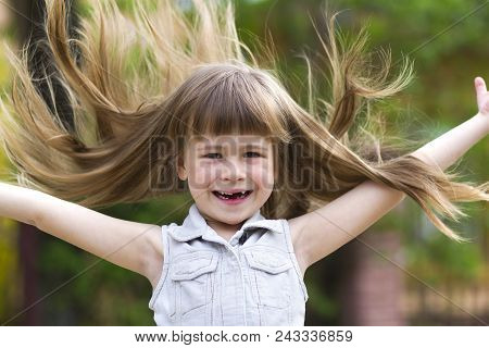 Pretty Little Preschool Girl In Sleeveless White Dress With Beautiful Long Blond Hair Blown By Wind,