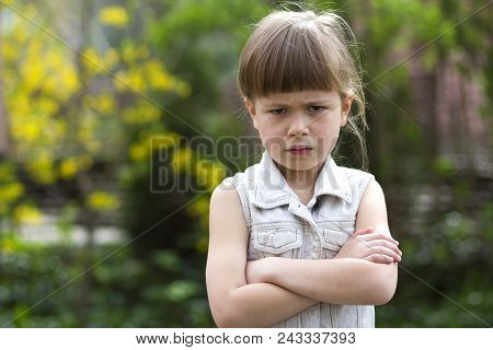 Pretty Funny Moody Little Blond Preschool Girl In White Sleeveless Dress Looks Into Camera Feeling A