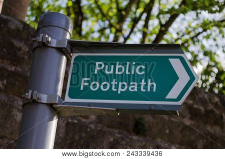A Clean And Clear Metal Signpost Giving The Direction Of A Public Footpath.