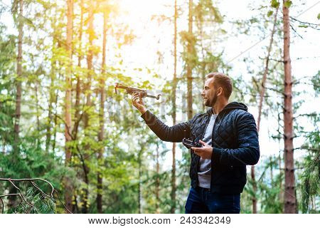 Guy Starts A Quadrocopter In The Forest, A Close View