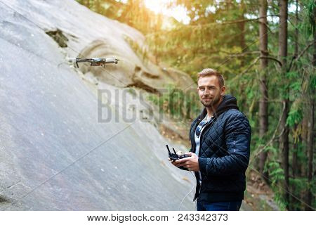 Guy Starts A Quadrocopter In The Forest, A Close View
