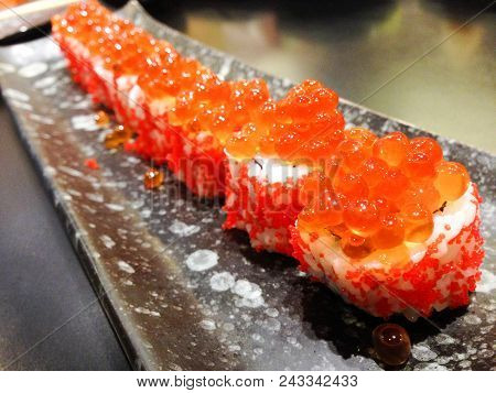 Japanese Rice Roll With Salmon Roe On Top And Seaweed Inside, Lay On Japan Disk Style. Shooting In A