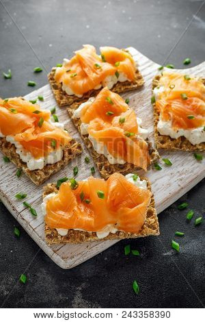 Homemade Crispbread Toast With Smoked Salmon And Soft Chees, Chives On White Board.