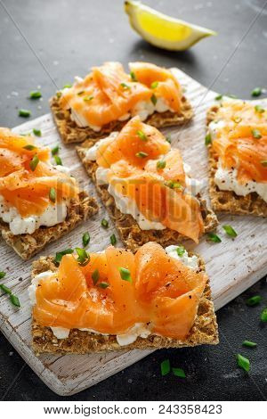 Homemade Crispbread Toast With Smoked Salmon And Soft Chees, Chives On White Board.