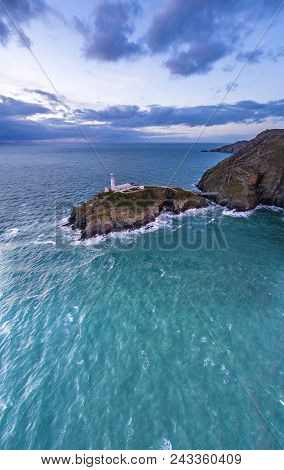Aerial View Of South Stack With Lighthouse During Sunset.