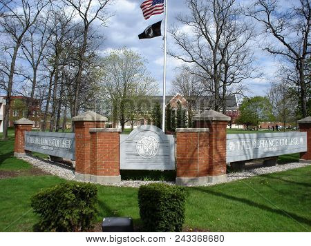 Defiance College Sign And Flag Pole Flying The United States Of American National Flag, Defiance, Oh