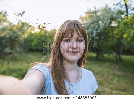 Stylish Modern Girl Taking A Selfie Out In The Park.