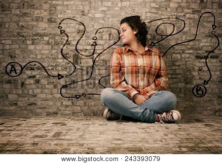 Young Woman Sits On A Concrete And Looking To Path Drawn On Wall , Point A To Point B.