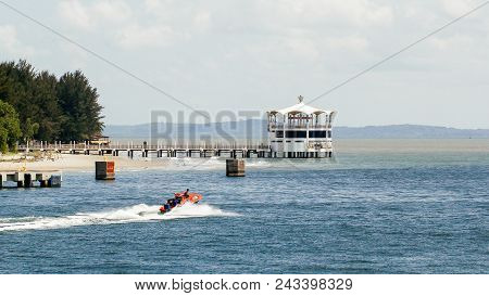 Labuan,malaysia-feb 2,2018:water Taxi Boat Service With Background Of The Iconic Floating Restaurant
