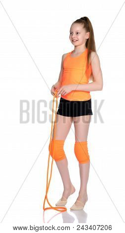 A Girl Gymnast Performs Exercises With A Skipping Rope. The Concept Of A Healthy Lifestyle, Sports E