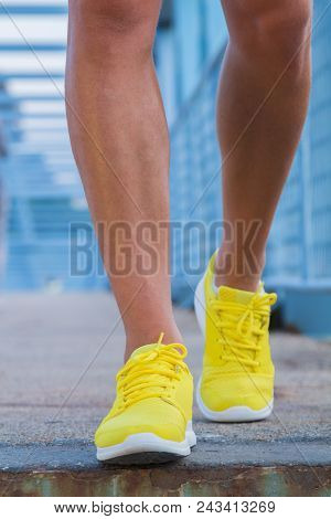 Close-up Of Man's Running Shoes While Walking Towards The Camera.