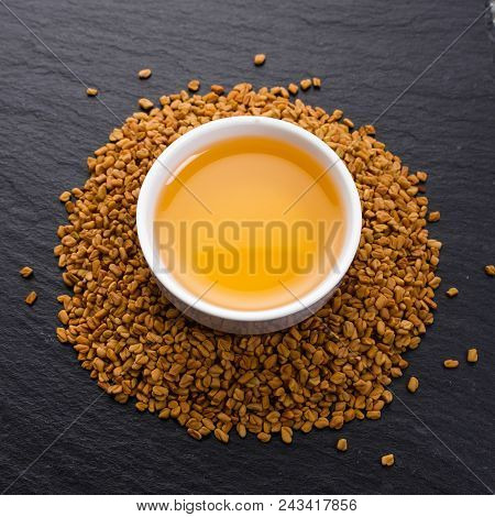 Fragrant Grains Of Fenugreek On A Rustic Background.