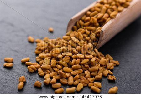 Fragrant Grains Of Fenugreek On A Rustic Background.