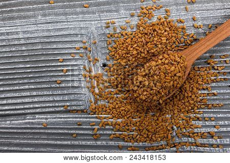 Fragrant Grains Of Fenugreek On A Rustic Background.