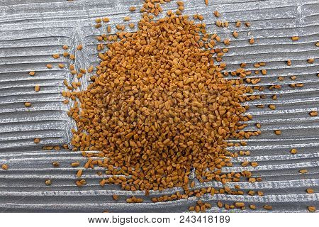 Fragrant Grains Of Fenugreek On A Rustic Background.